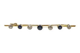 An early to mid 20th century yellow metal, four stone sapphire and three stone diamond set bar