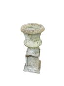 A circular reconstituted stone campana urn on square pedestal, height 80cm