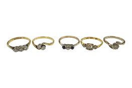 An 18ct, plat and three stone diamond ring, size O, a similar three stone diamond chip set ring,