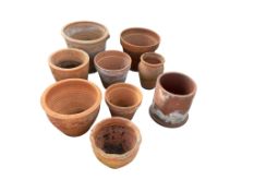 Nine terracotta planters, largest diameter 39cm, height 34cm