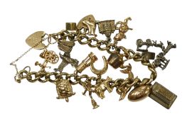 A 9ct gold curb link charm bracelet, hung with 9ct or sterling charms including dolphin, turtle,