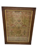 A 19th century alphabet sampler worked with flowers, motifs, and initials, oak framed, 60 x 43cm