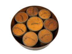 A Victorian or later circular spice box, containing eight labelled spice canisters, diameter 23cm