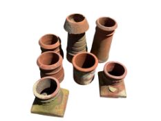A terracotta strawberry planter and three others, largest height 40cm