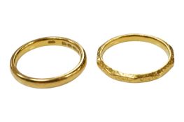 Two 22ct gold wedding bands including one with engraved decoration, 6.7 grams.