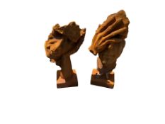 A pair of rust effect cast iron faces, height 61cm and 57cm