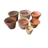 Eight terracotta pots, largest diameter 39cm, height 32cm