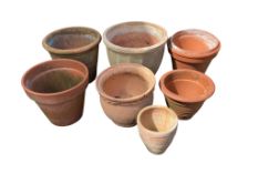 Eight terracotta pots, largest diameter 39cm, height 32cm
