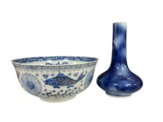 A Chinese blue and white bowl decorated with fish amongst waves, together with a flambé-glazed