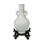 A Chinese white glazed two handled bottle vase, late 19th/early 20th century, wood stand, total