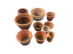 Ten terracotta pots, largest diameter 43cm, height 24cm