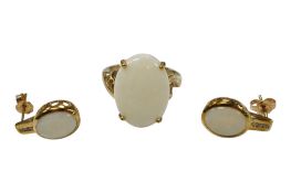 A recent 9ct gold and single stone oval white opal set ring, M/N, together with a similar pair of