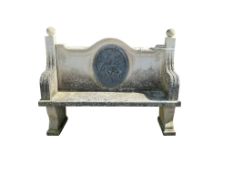 An impressive stone garden seat, the back inset oval lead panel, width 180cm, depth 53cm, height