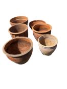 Six terracotta pots, largest width 43cm, height 36cm