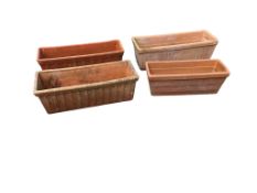 Four rectangular terracotta planters, largest width 53cm, depth 19cm, height 17cm