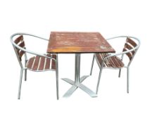 A slatted teak and aluminium square garden table, 70cm, height 74cm together with two matching