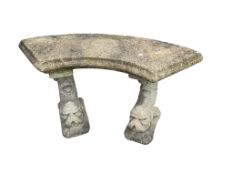 A reconstituted stone curved garden bench on twin dolphin supports, width 104cm, depth 45cm,