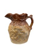 A Doulton Lambeth stoneware jug by Doulton & Watts, relief decorated with flowering foliage, 20cm