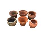 Six terracotta pots, largest diameter 31cm, height 27cm