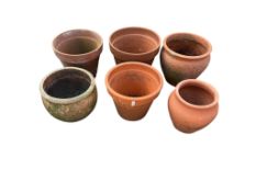 Six terracotta pots, largest diameter 31cm, height 27cm