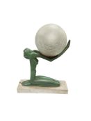 A French Art deco green patinated spelter figural table lamp formed as a kneeling female nude
