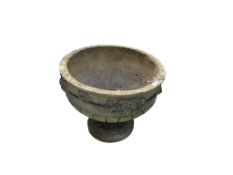 A reconstituted stone urn on a base, diameter 66cm, height 54cm