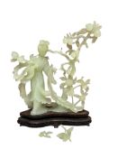 A Chinese carved celadon figure group of a dancer on a wooden stand, 25cm high.