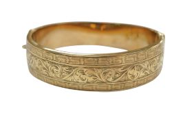A late 20th century engraved 9ct hinged bangle, inner diameter approx. 58mm, 23.5 grams.