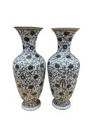 A pair of French porcelain floral vases, 38cm high