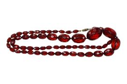 A single strand faceted simulated cherry amber bead necklace, 78cm, gross weight 57.4 grams.