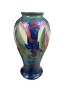 A William Moorcoft vase in the leaves and berries pattern, signed to the base, 25cm high