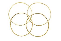Two recent engraved 22ct gold bangles, 18.8 grams and two Middle Eastern engraved yellow metal