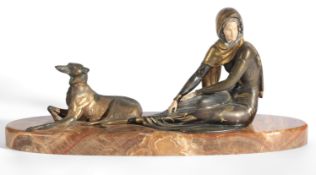 An Art Deco bronzed metal group of seated female and borzoi raised on an oval brown onyx base,