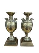 A pair of brass Egyptian Revival candlesticks, height 25cm