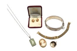 A recent 9ct gold mounted oval cameo shell brooch, a pair of similar ear studs, a silver hinged