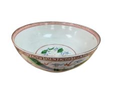 A Japanese porcelain punch bowl decorated with dragons chasing the flaming pearl, 33cm in diameter