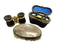 A silver backed clothes brush engraved with musical score, tortoiseshell Lemaire opera glasses,