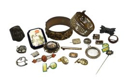 A small collection of assorted costume jewellery including hinged bangles, brooches and rings.