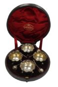 A cased set of four late Victorian silver salts and four spoons by The Goldsmiths and Silversmiths
