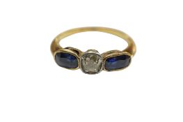 A unmarked yellow metal, single stone diamond and two stone sapphire set ring, size M, gross