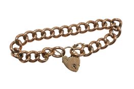 A 9ct gold curb bracelet, circa 1948, to a heart-shaped padlock clasp, length 18cm, British