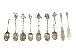 Five continental white metal teaspoons, together with one other damaged spoon and a pair of George V