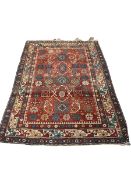An antique Caucasian brick red ground rug, 177 x 125cm