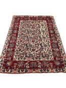 A pair of Tabriz red ground rugs, 216 x 152cm