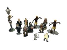 A collection of cold-painted metal and pottery figures, depicting various characters including