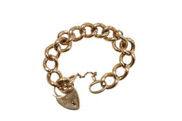 An early to mid 20th century yellow metal hollow curb link bracelet with heart shaped padlock clasp,