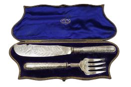 A cased pair of Victorian engraved silver fish servers, by George Adams, London 1870, decorated with