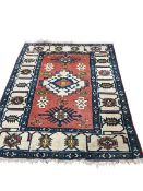 A Turkish brick red ground rug, 190 x 148cm