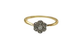 A yellow metal and seven stone diamond set flower head ring, sizes, gross weight 2.8 grams.