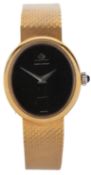 Baume and Mercier, a lady's gold wrist watch, the oval black dial within a polished bezel, the crown
